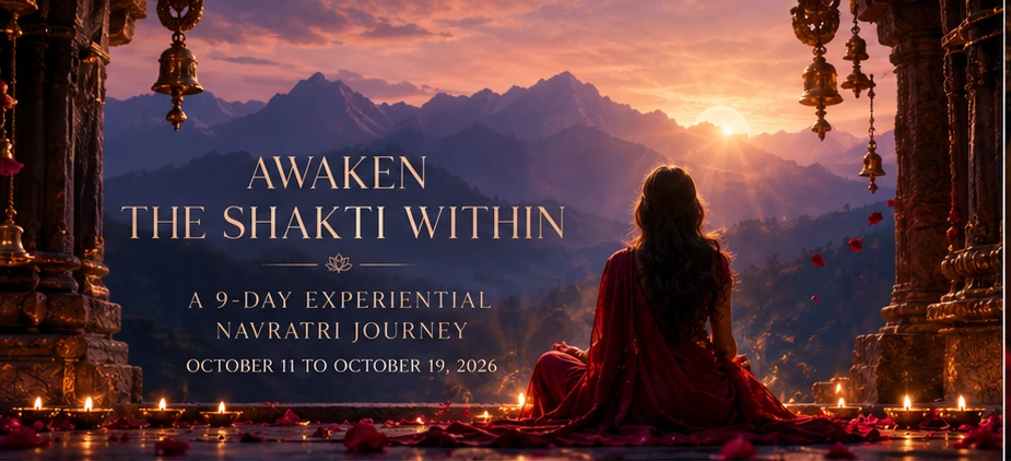 A woman seated at a mountain temple threshold at sunset, before a rising sun, with diyas and rose petals at her feet — Awaken the Shakti Within, a 9-day experiential Navratri journey, October 11 to October 19, 2026